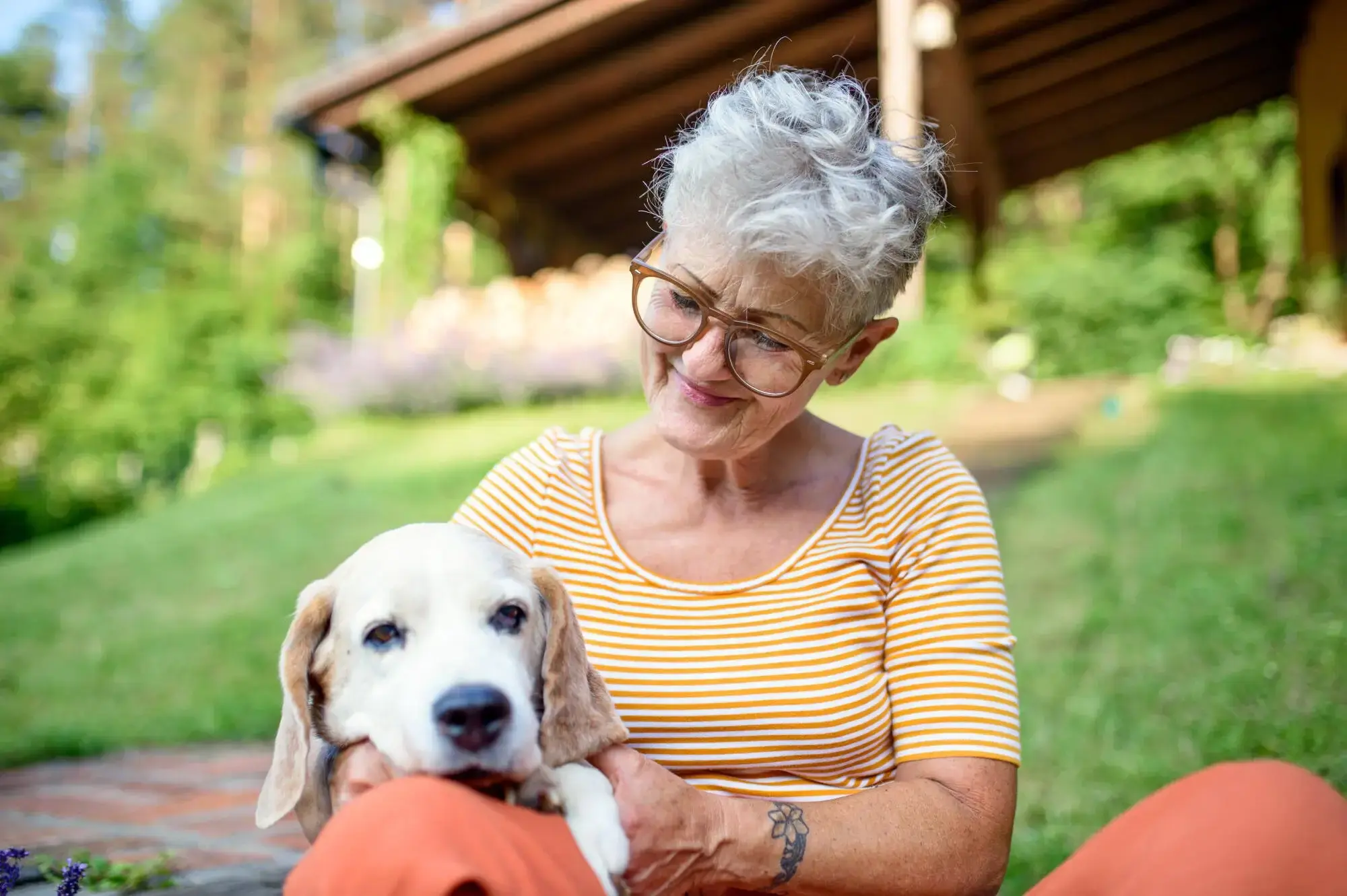 Portrait of senior woman sitting with her pet