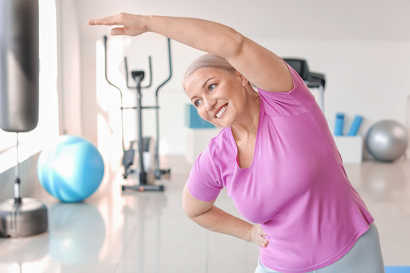 Sporty mature woman training in gym