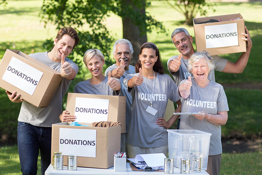 Happy volunteer family with thumbs up