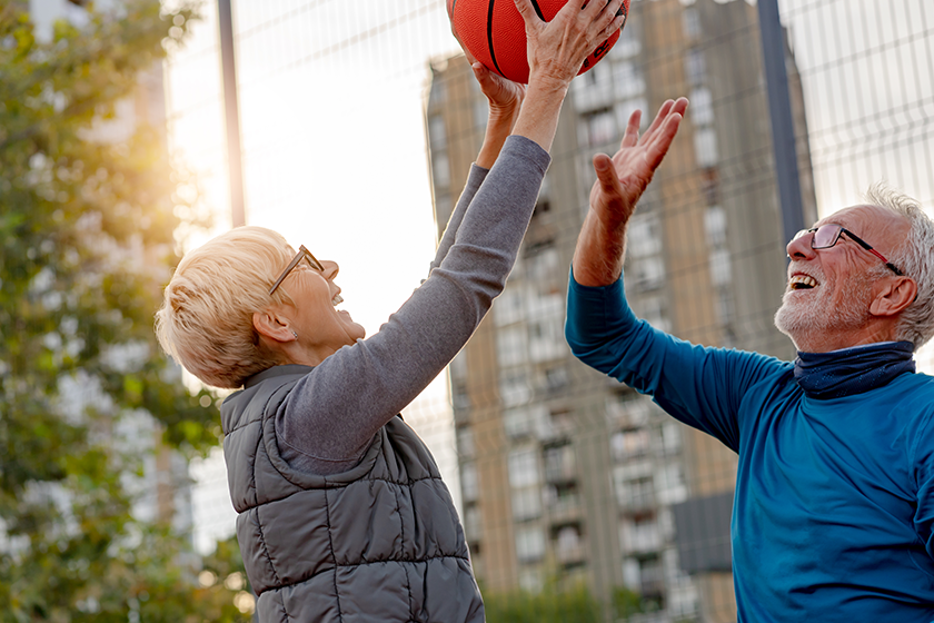 senior-woman-mature-man-playing-basketball