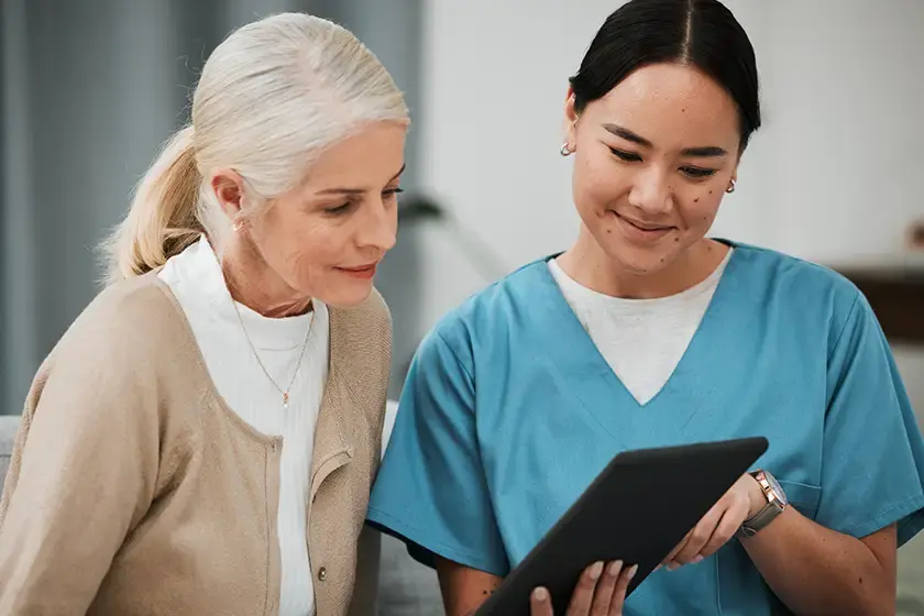 nurse and old woman consulting sugery 